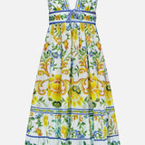 The Emily Floral Tapestry Midi Dress by FARM RIO features a sleeveless V-neck, flared skirt, yellow and green floral prints, blue trim, and a waistband bow on white—ideal for summer style.