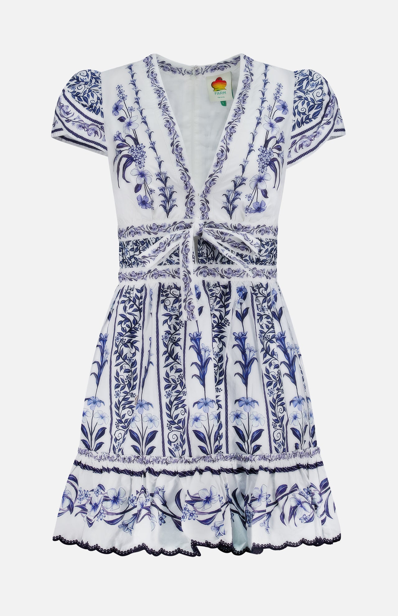 The Flowers Arch Mini Dress by FARM RIO features short sleeves, a v-neckline, white and blue floral patterns, gathered front tie, fitted waist, ruffled hem with piping, and intricate vertical botanical designs for added elegance.