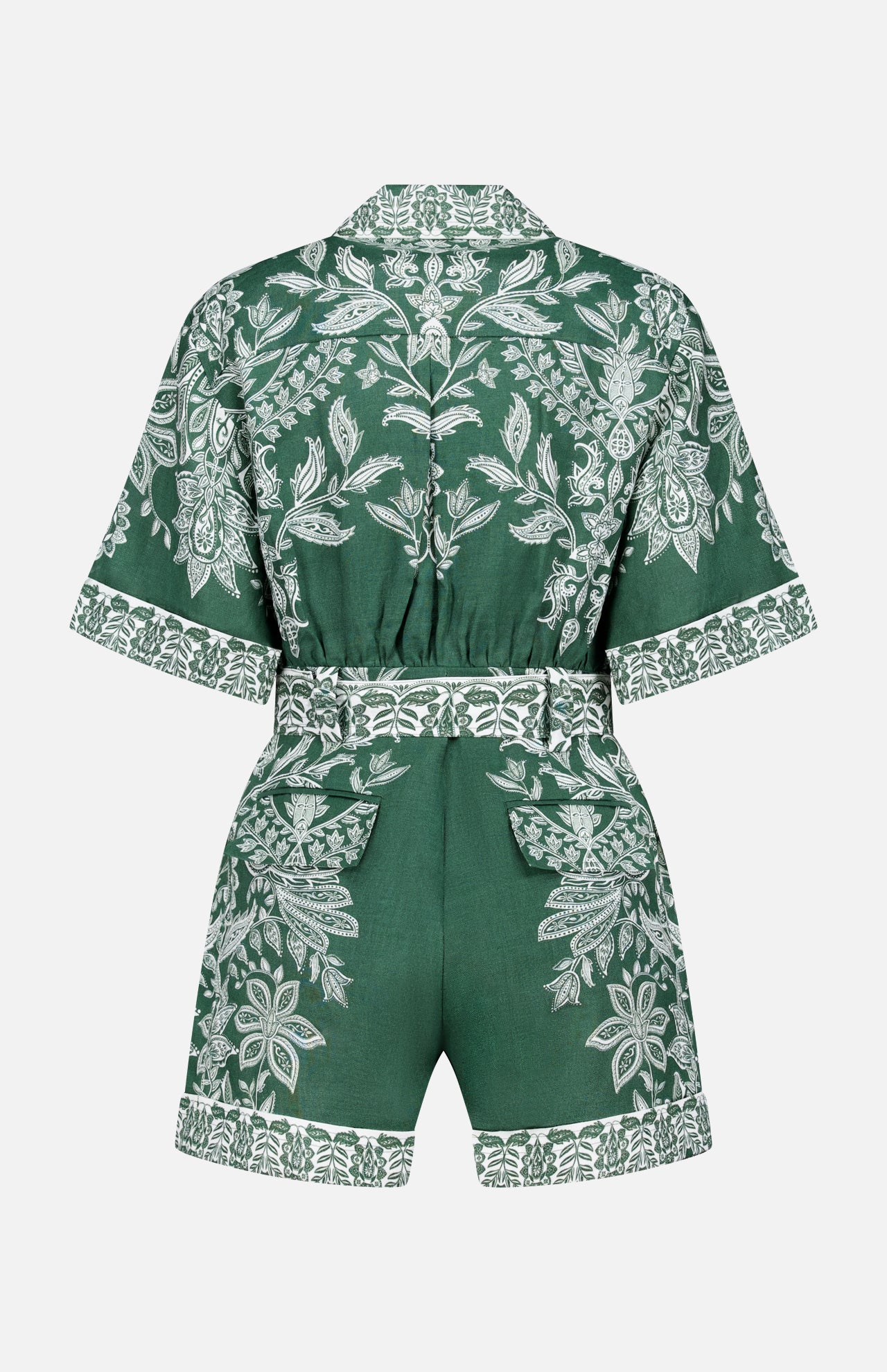 The FARM RIO Miranda Short Sleeve Belted Romper features green linen fabric with a belted waist and white floral and leaf embroidery on the back, sleeves, and hem, shown against a white background.
