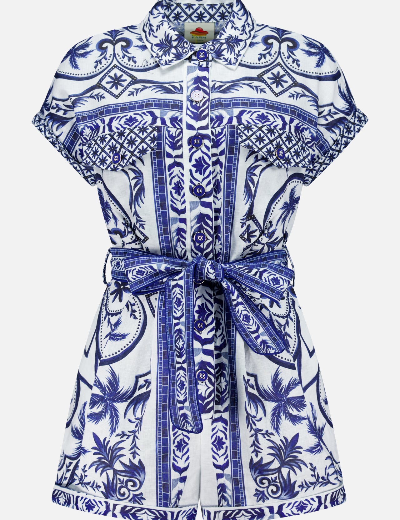 The FARM RIO Wonderful City Linen Romper features short sleeves, a collared neckline, a blue and white nature-inspired floral and geometric print, a button-down front, and a matching fabric belt at the waist.