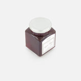 A square glass jar of FLAMINGO ESTATE's Golden Saffron Honey, topped with a white lid and front label in their signature style, sits on a plain white background.