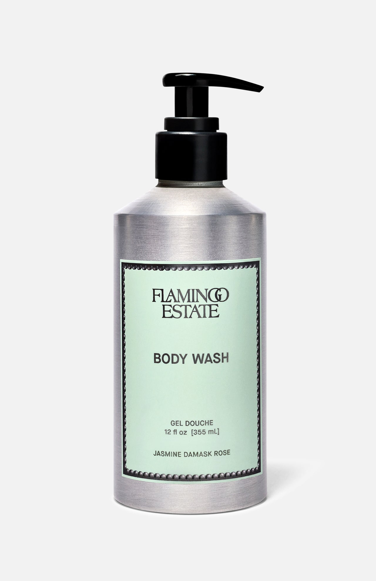 A silver pump bottle of FLAMINGO ESTATE Jasmine Damask Rose Body Wash with a light green label and BODY WASH text, infused with natural sea salt, is shown against a plain light background.