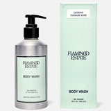 A silver pump bottle and mint green box of FLAMINGO ESTATE Jasmine Damask Rose Body Wash, enriched with natural sea salt, 12 fl oz (354 mL), with minimalist black-and-white labeling.