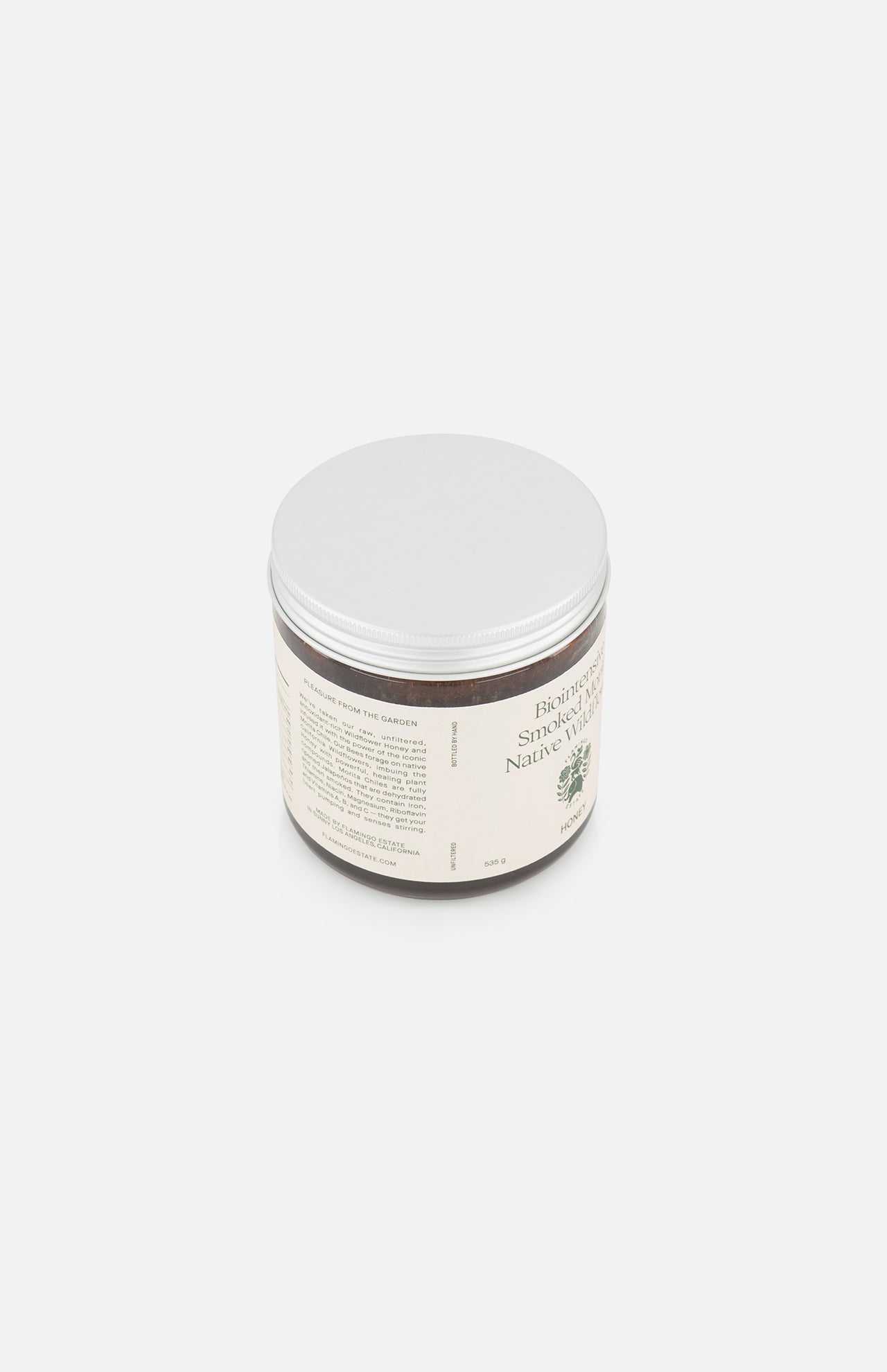 A 19 oz brown plastic jar of Morita Chile Honey by FLAMINGO ESTATE, with a silver lid and cream label featuring text and a green leaf graphic, sits against a plain white background.