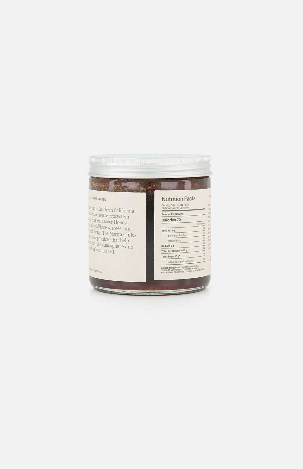 A clear plastic jar with a white lid contains FLAMINGO ESTATE’s Morita Chile Honey (19 oz), featuring a brown spread made with unfiltered honey. The back label shows nutrition facts and product info in black on a white background.