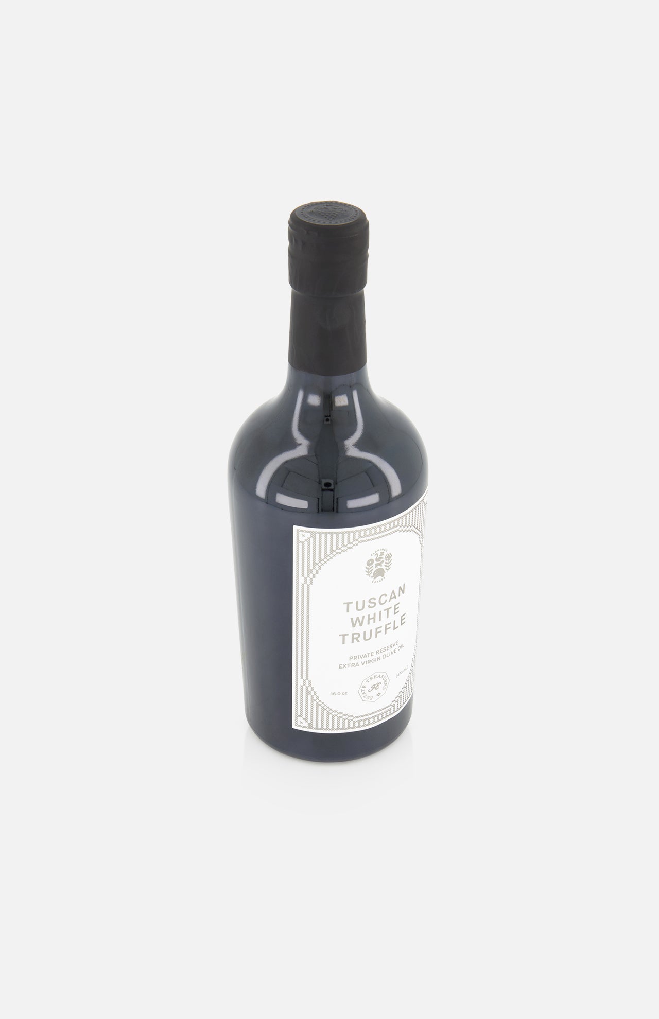 A dark glass bottle with a black cap and a white label reading FLAMINGO ESTATE White Truffle Extra Virgin Olive Oil sits on a white background, highlighting this premium offering.