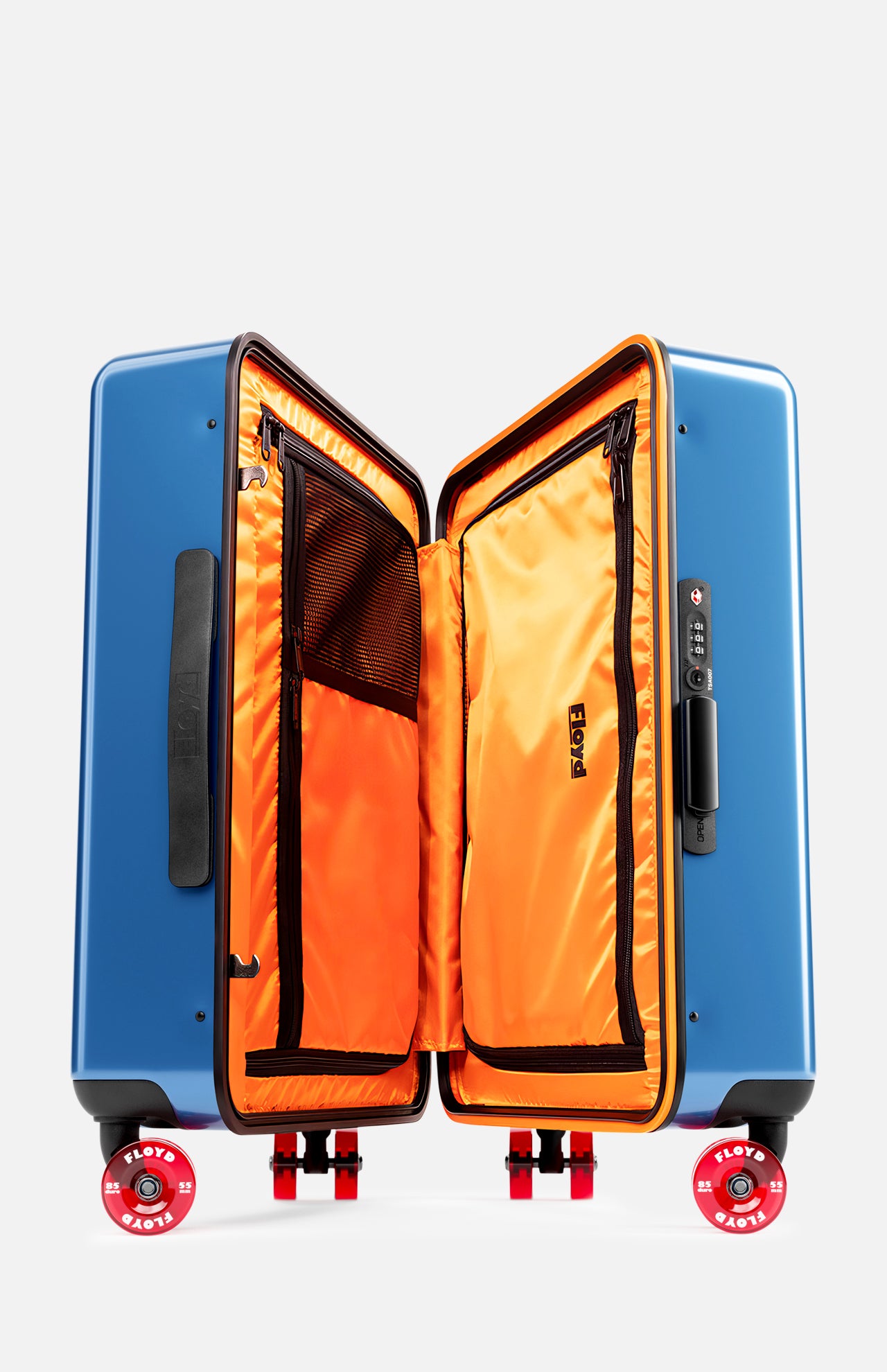 The FLOYD Cabin Suitcase features a blue hard-top shell, bright orange interior with mesh and zippered compartments, skateboard-style spinner wheels with branding, and a built-in TSA lock on the side.