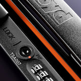 Close-up of The Check-In Suitcase’s black hard-top lock with FLOYD branding, orange accent, TSA007 code, red TSA logo, and a three-digit combination lock.