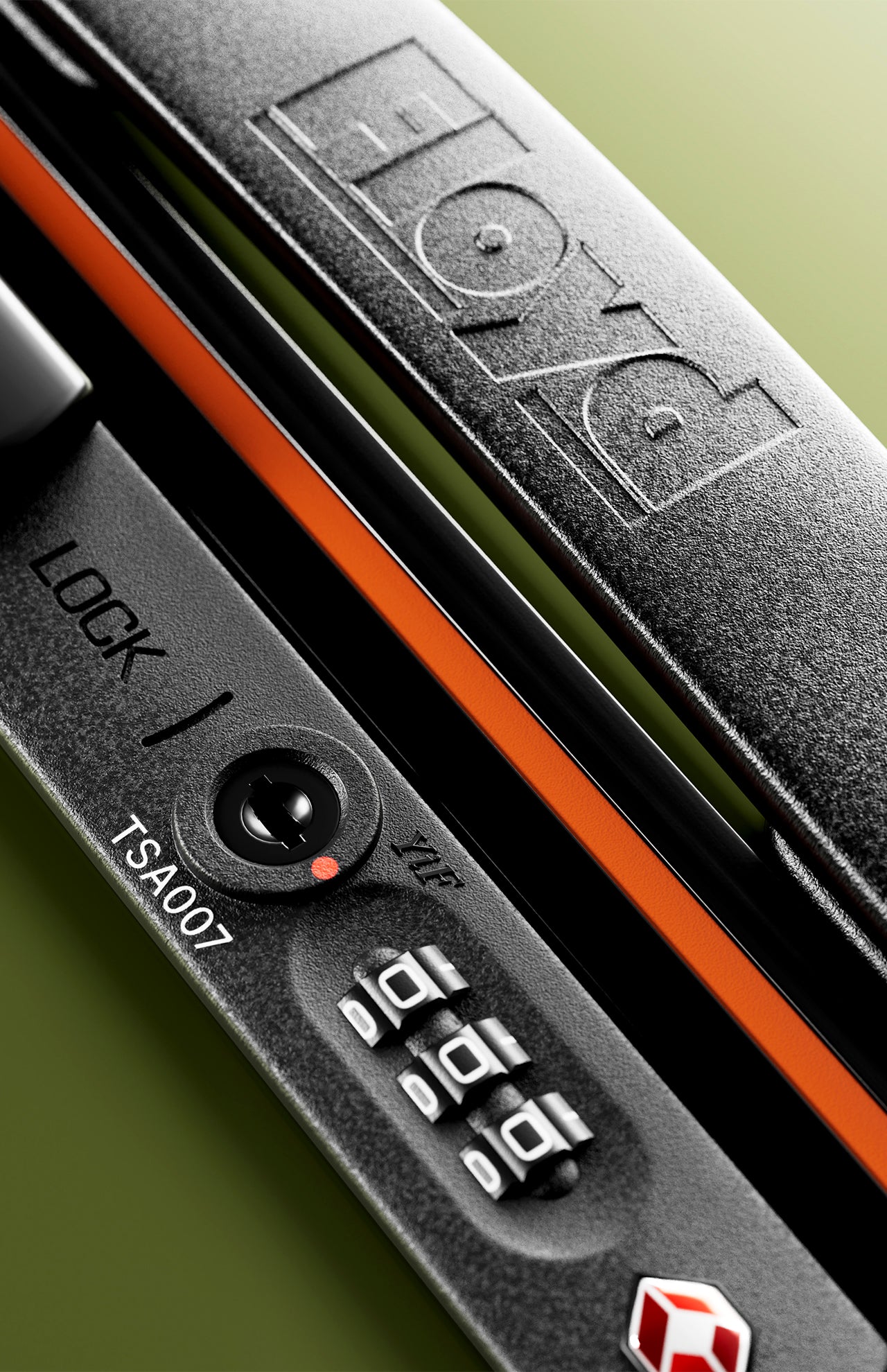 Close-up of The Check-In Suitcase by FLOYD: a black hard-top lock with a combination dial, "LOCK" and "TSA007" printed nearby, FLOYD engraved on the handle, plus an orange accent strip beneath.