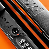 Close-up of a black TSA007 combination lock labeled "LOCK" on an orange hard-top FLOYD The Check-In Suitcase, with the FLOYD brand name embossed above the lock.