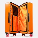 The FLOYD Check-In Suitcase is a bright orange hard-top case with a built-in TSA lock, black handles, and skateboard spinner wheels. Its orange interior offers zippered mesh compartments and black trim for organized packing and easy mobility.