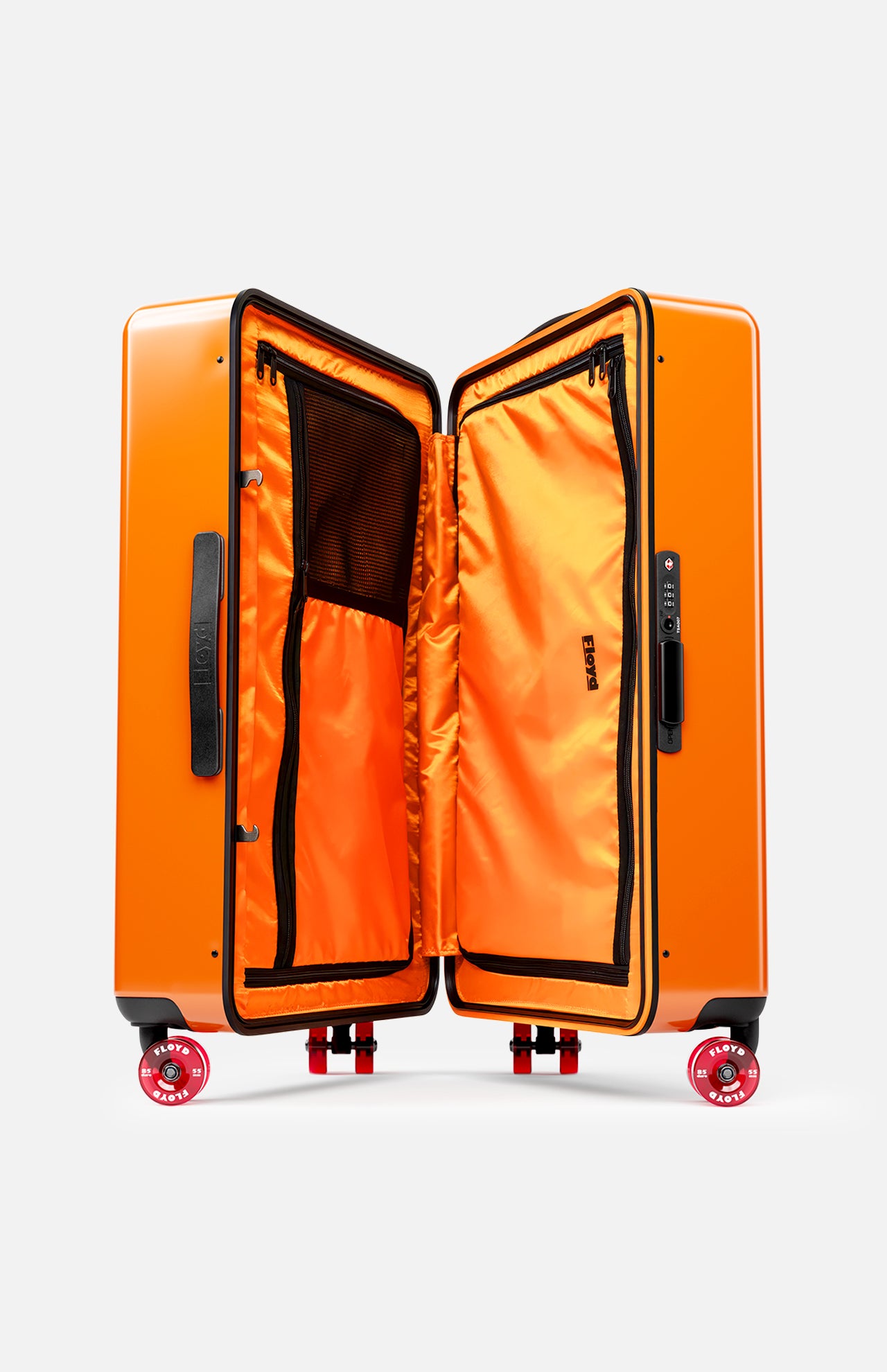 The FLOYD Check-In Suitcase is a bright orange hard-top case with a built-in TSA lock, black handles, and skateboard spinner wheels. Its orange interior offers zippered mesh compartments and black trim for organized packing and easy mobility.