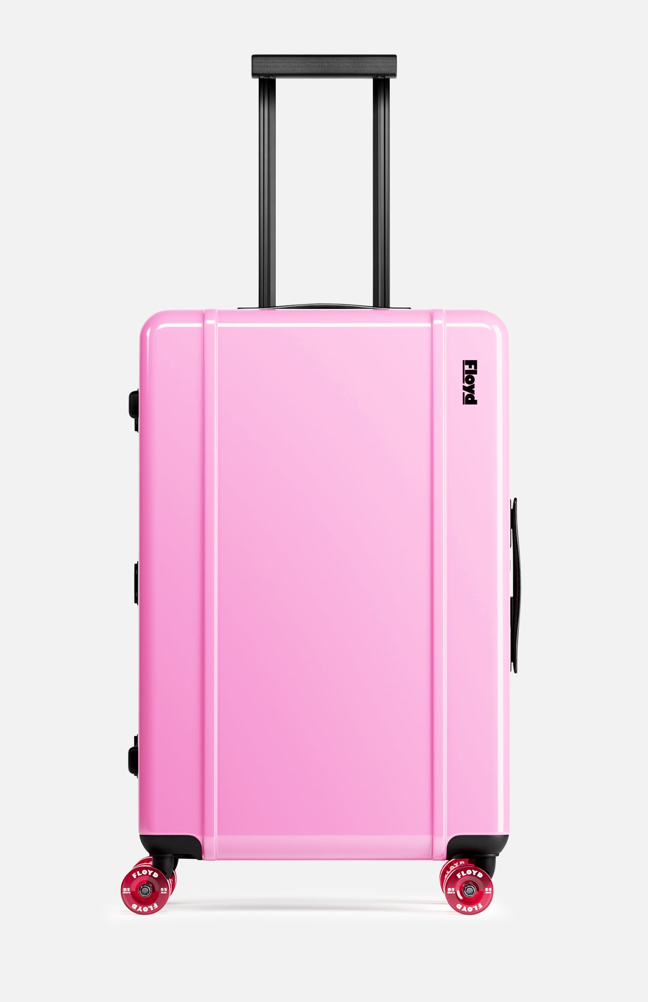 The FLOYD Check-In Suitcase, a hard-top pink case with black handles, a TSA lock, and four red 360° spinner wheels, stands upright against a plain white background.