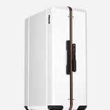 The Check-In Suitcase by FLOYD stands upright on a light gray background, featuring a modern white hard-top design, black handle, orange accent line, and four red transparent skateboard-style spinner wheels.