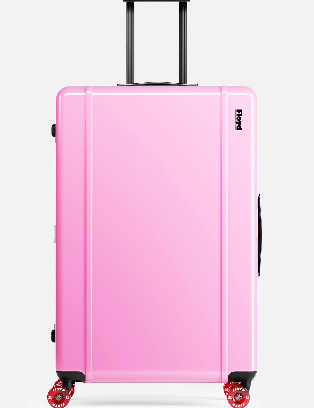 The Trunk Suitcase by FLOYD is a hard-top, pink rolling suitcase with a black handle and four 360° spinner wheels, pictured upright against a plain white background.