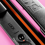 Close-up of The Trunk Suitcase’s black TSA lock by FLOYD, featuring a combination dial, LOCK / ZIP keyhole, and TSA007 code—ideal for securing your hard-top case—set against a pink background.
