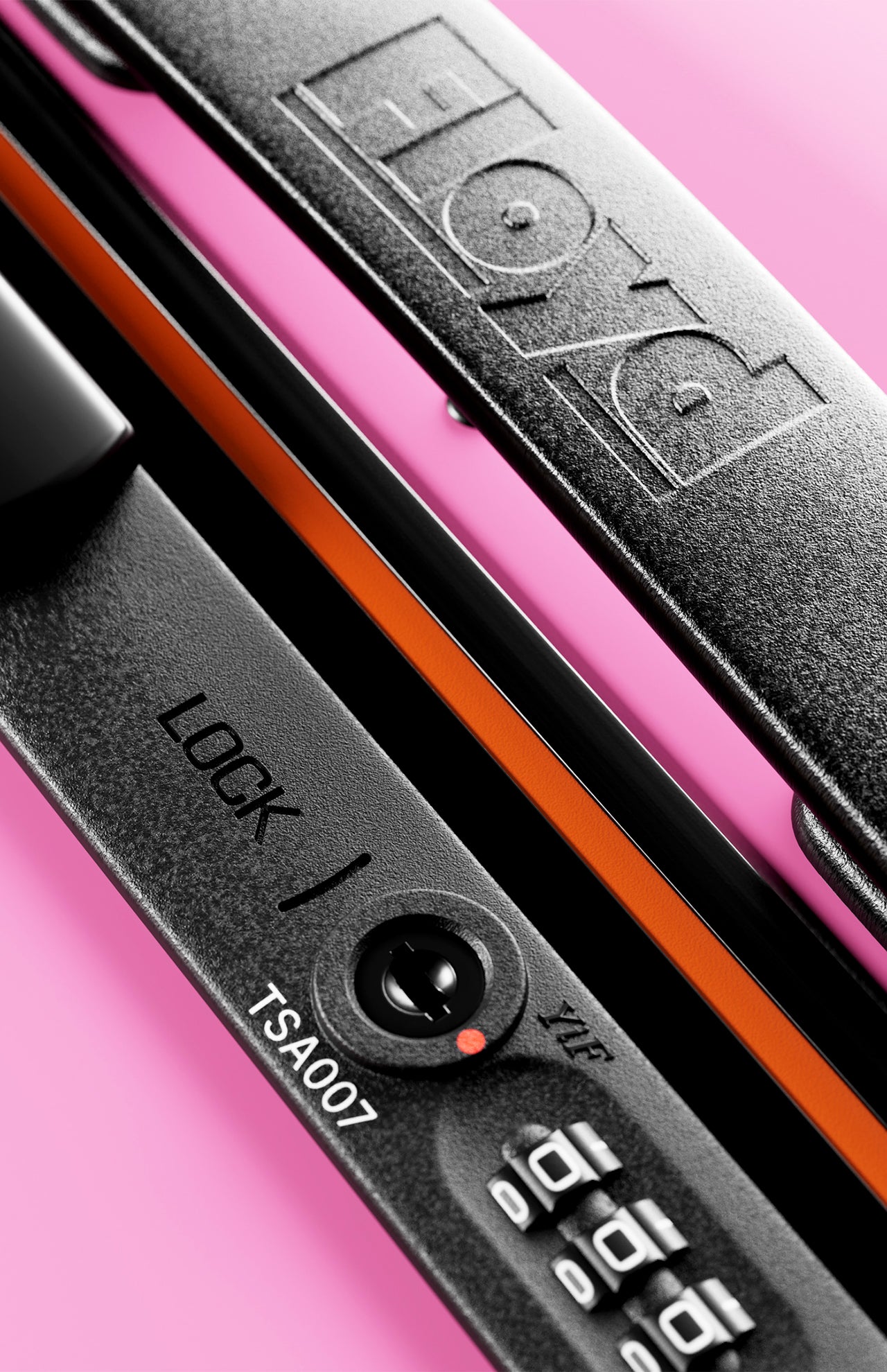 Close-up of The Trunk Suitcase’s black TSA lock by FLOYD, featuring a combination dial, LOCK / ZIP keyhole, and TSA007 code—ideal for securing your hard-top case—set against a pink background.