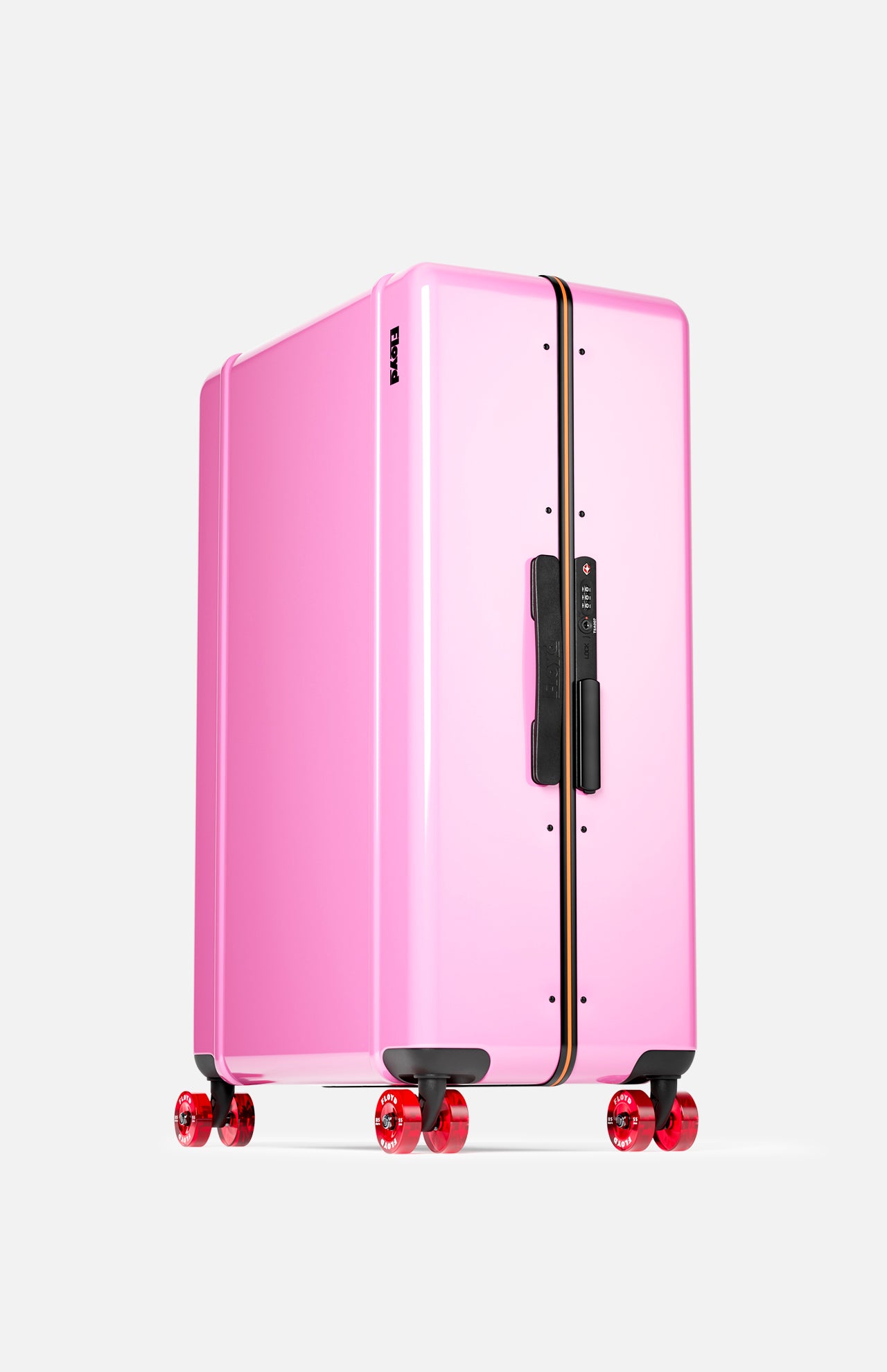 The Trunk Suitcase by FLOYD stands upright against a plain white background, featuring a large, glossy pink hard-top shell, black handle, TSA lock, and four red transparent 360° spinner wheels.