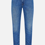 The L’Homme Slim Jean in Verdugo by Frame is a pair of dark blue slim fit jeans, crafted from premium stretch denim. They feature a button and zip fly, front and back pockets, and subtle fading on the thighs and knees.