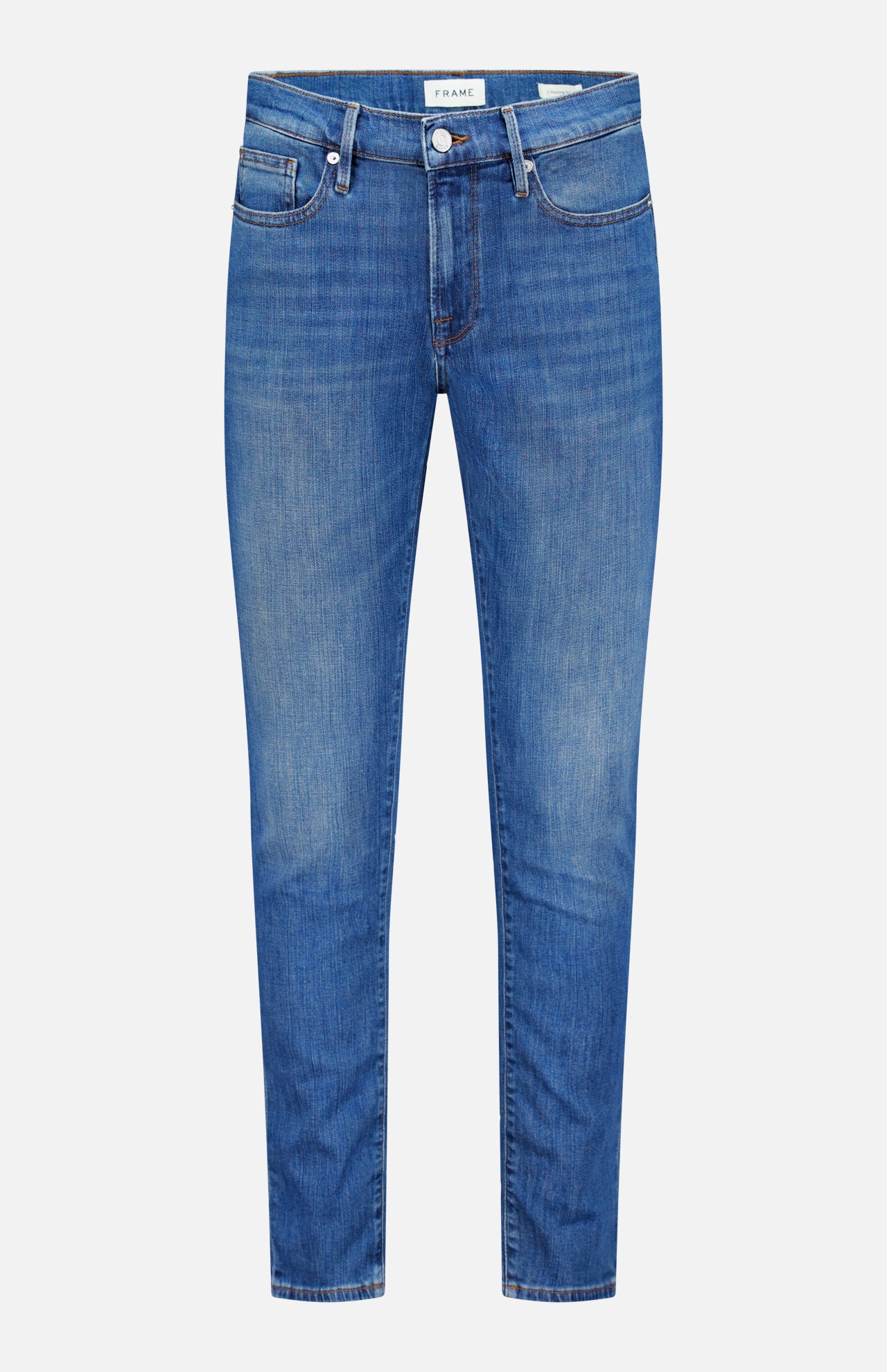 The L’Homme Slim Jean in Verdugo by Frame is a pair of dark blue slim fit jeans, crafted from premium stretch denim. They feature a button and zip fly, front and back pockets, and subtle fading on the thighs and knees.