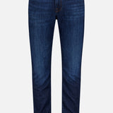 A pair of Frame L’Homme Slim Jeans in Baltic, crafted from premium stretch denim with an ultra-dark blue wash, featuring a slim fit silhouette, five-pocket styling, orange stitching, and a button closure, displayed against a plain white background.