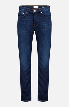 A pair of Frame L’Homme Slim Jeans in Baltic, crafted from premium stretch denim with an ultra-dark blue wash, featuring a slim fit silhouette, five-pocket styling, orange stitching, and a button closure, displayed against a plain white background.