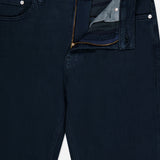 A close-up of the Frame Modern Straight Pant in Placid, featuring straight-leg comfort stretch denim in dark navy with a partially unzipped zipper and open waistband, highlighting the inside pocket and button details.