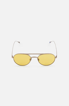 The GARRETT LEIGHT Benny J Round Natural Sunglasses feature thin metallic frames and yellow-tinted lenses, displayed against a plain white background.