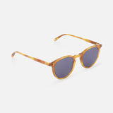 The GARRETT LEIGHT Carlton Round Tan Sunglasses feature amber-colored bio-based acetate frames, dark lenses, and slim curved arms for a modern style, shown on a white background.