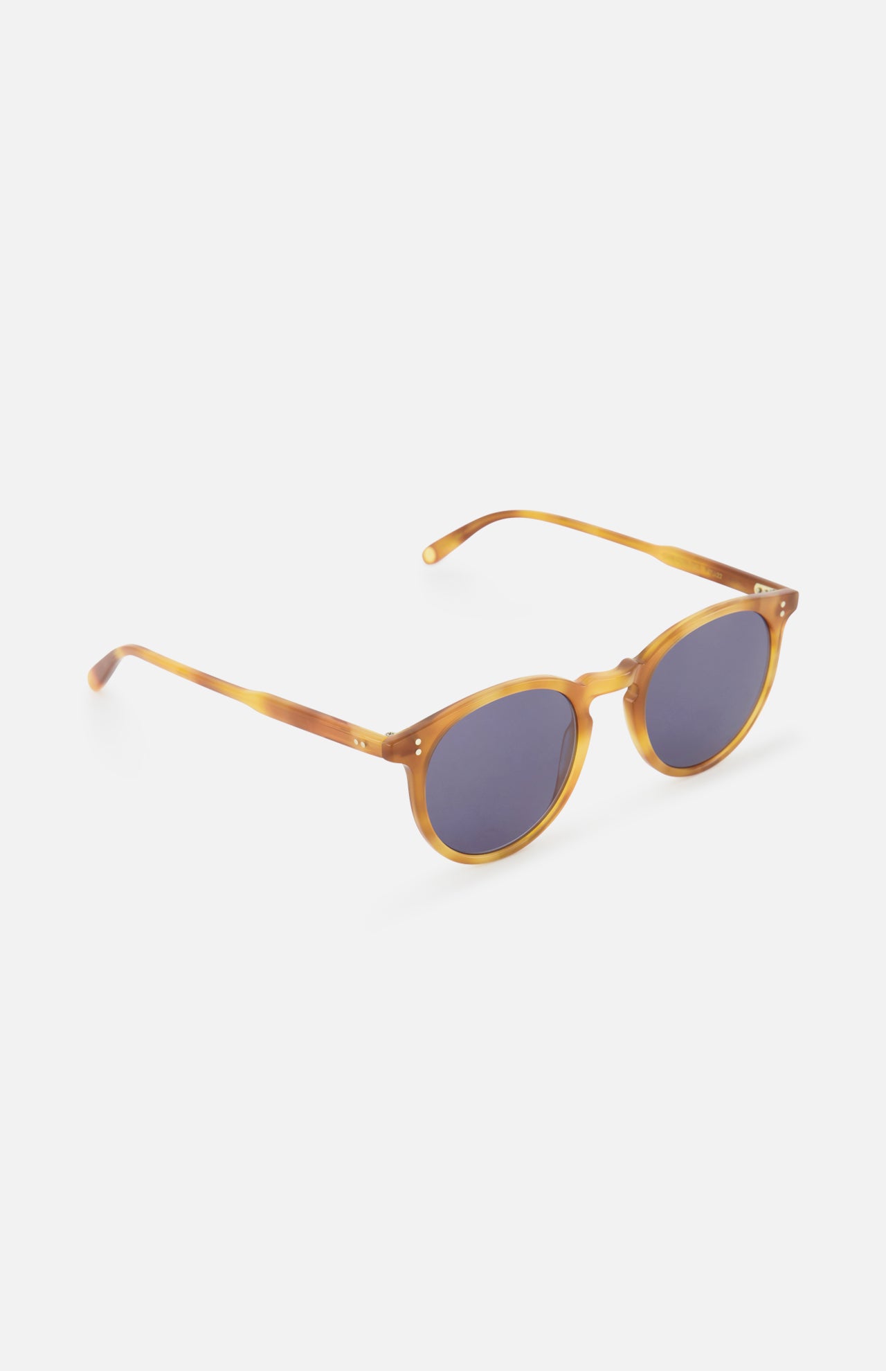 The GARRETT LEIGHT Carlton Round Tan Sunglasses feature amber-colored bio-based acetate frames, dark lenses, and slim curved arms for a modern style, shown on a white background.