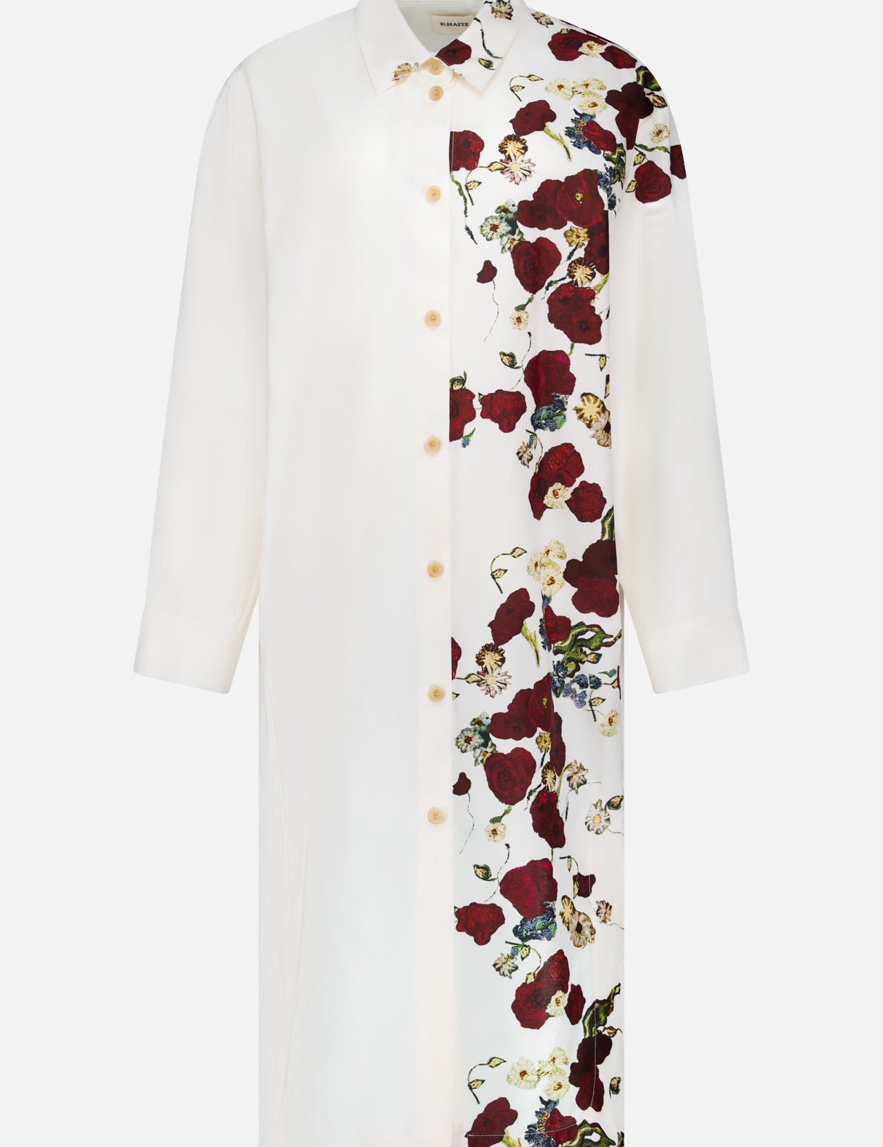 The KHAITE Gloria Cocoon Shape Dress is a white, long-sleeved silk-cotton dress with a collar and button-down front. It showcases a bold red floral pattern on one side, offering a modern twist on the classic floral print dress.
