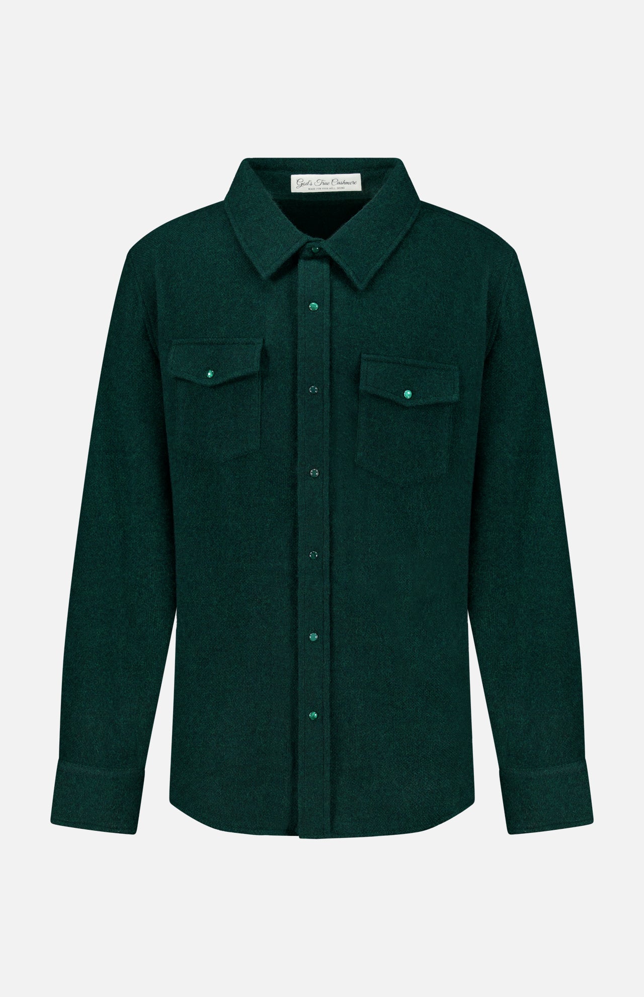 The Solid Cashmere Shirt with Malachite Buttons by God’s True Cashmere is a dark green unisex button-up featuring long sleeves, a pointed collar, adjustable cuffs, and two chest pockets with flaps and malachite buttons. Expertly crafted from soft cashmere for a luxurious feel, it is displayed against a plain white background.