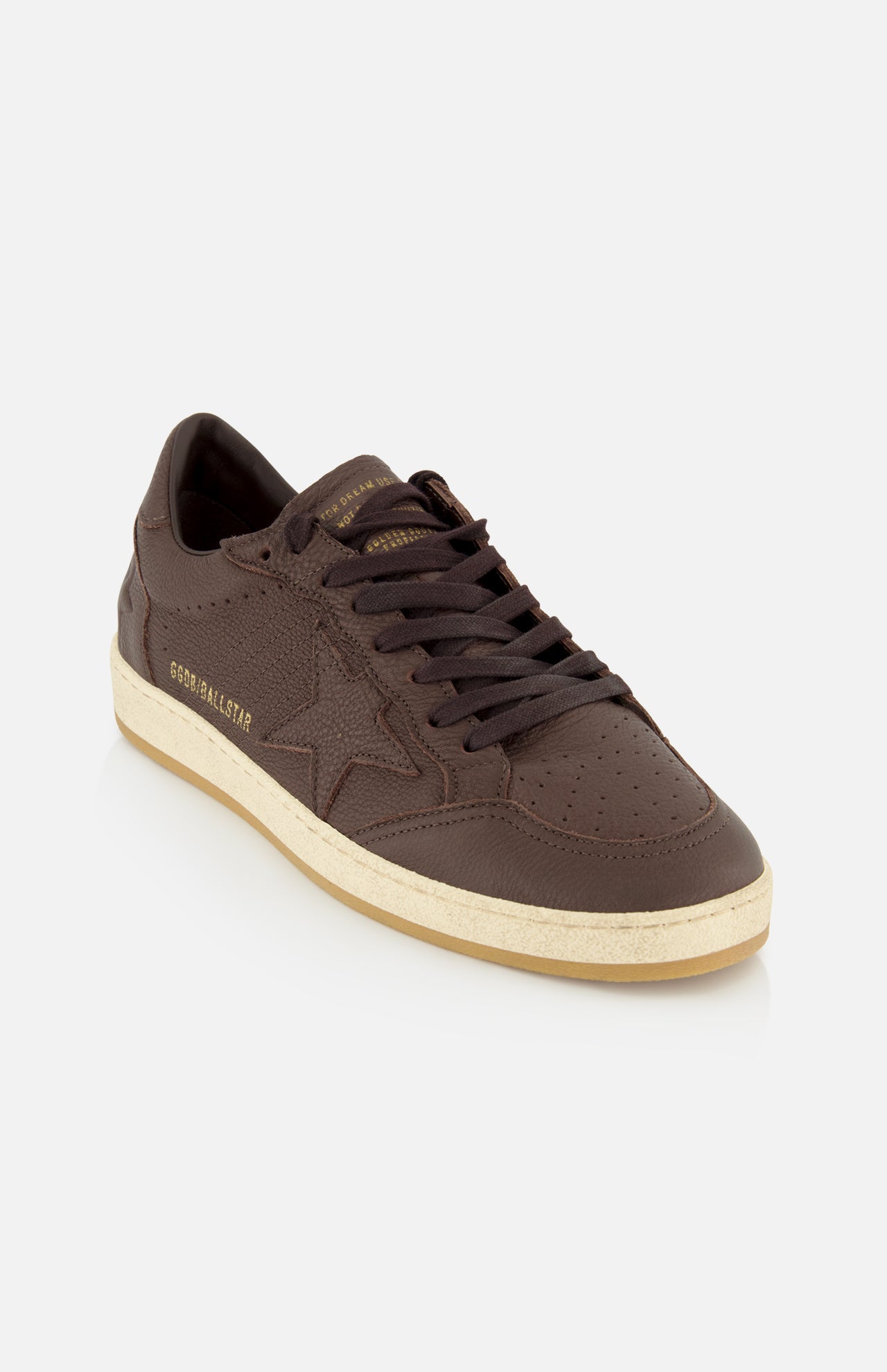 A dark brown Ballstar Leather Upper Sneaker by GOLDEN GOOSE, featuring a beige, slightly scuffed sole, black laces, perforated details, and gold GOLDEN GOOSE branding on the side, photographed on a plain white background.