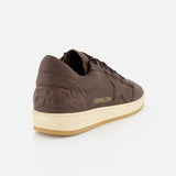The GOLDEN GOOSE Ballstar Leather Upper Sneaker features a brown low-top design with a beige scuffed sole and embossed star and text details, shown from the back left side against a white background—a classic silhouette inspired by iconic Golden Goose style.