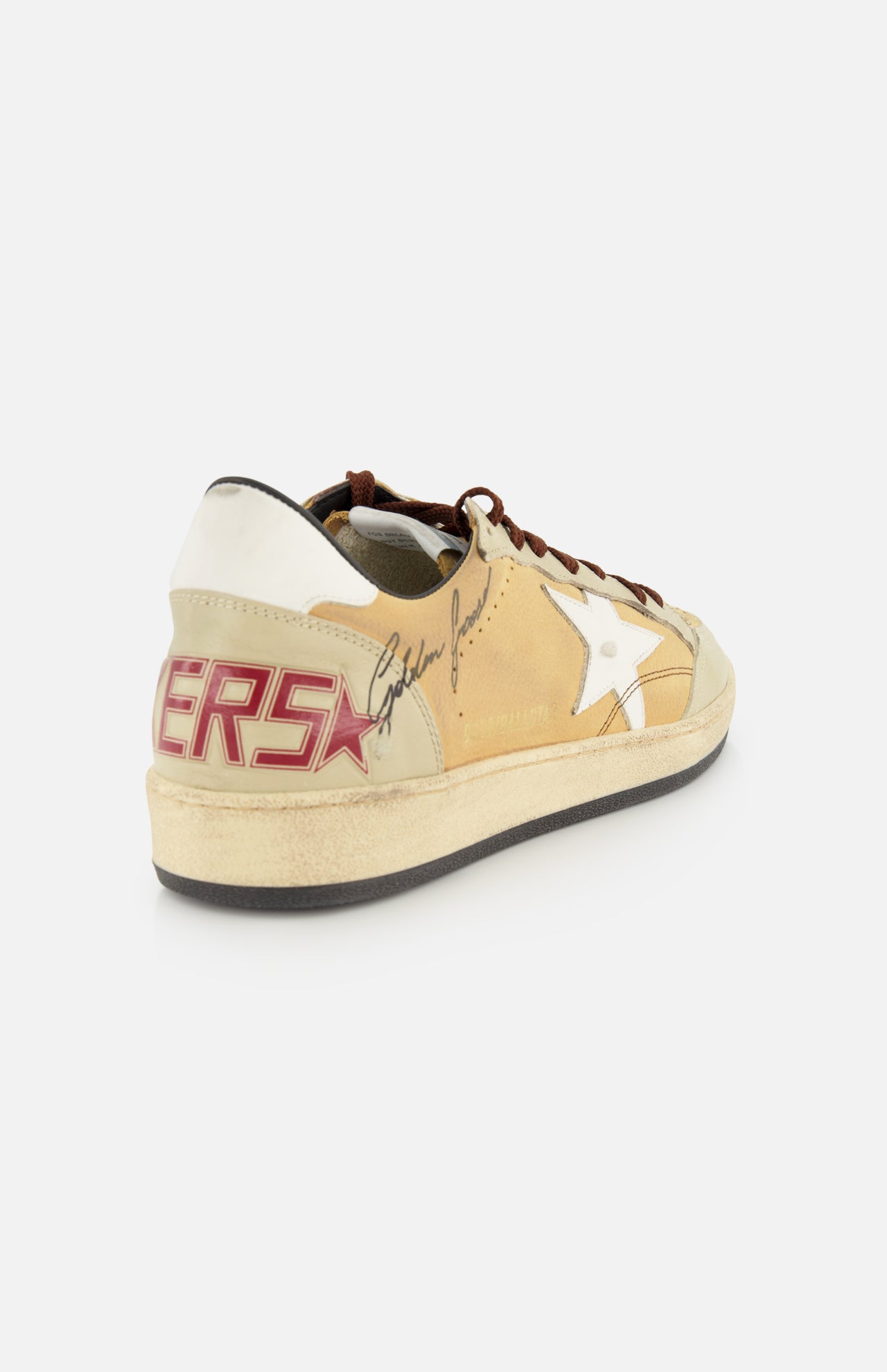 The GOLDEN GOOSE Ballstar Nabuk Upper And Tongue Sneaker features a beige and white design with a star detail, brown leather laces, red ERS lettering on the heel, and a black autograph on the side, displayed on a white background.