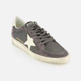 The Ballstar Nabuk Upper Suede Sneaker by GOLDEN GOOSE is a gray leather men's designer sneaker with a white star, perforated toe, gray laces, worn-look white sole, and GGBALLSTAR gold lettering.
