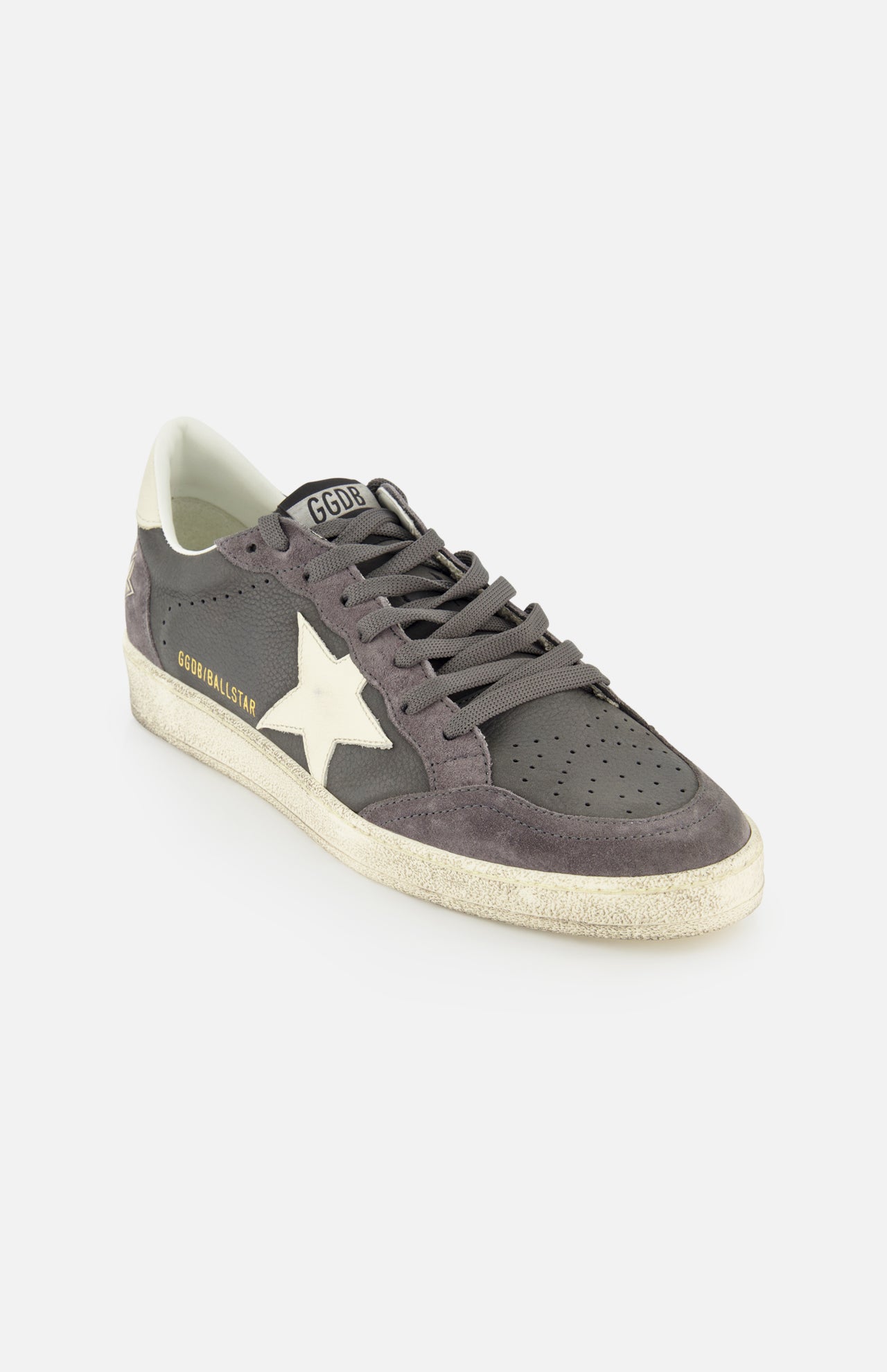 The Ballstar Nabuk Upper Suede Sneaker by GOLDEN GOOSE is a gray leather men's designer sneaker with a white star, perforated toe, gray laces, worn-look white sole, and GGBALLSTAR gold lettering.