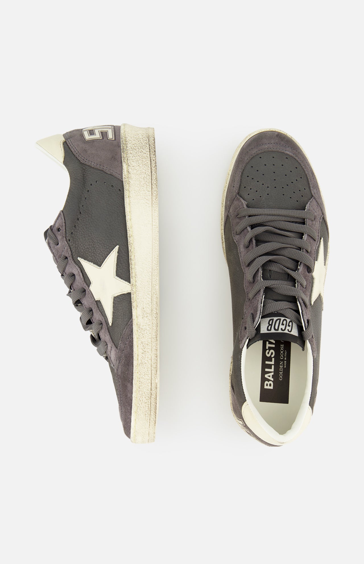 The GOLDEN GOOSE Ballstar Nabuk Upper Suede Sneaker is a men's designer shoe in dark gray leather with white soles, star-shaped accents, and white heel details, shown from side and top view on a plain white background.
