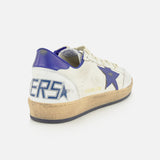 The Ballstar Nappa Upper Sneaker by GOLDEN GOOSE features a white leather upper, accented with a blue star and heel. GOLDEN GOOSE branding appears on the side, while “BALLSTAR” is displayed on the scuffed sole for a worn, vintage effect. The sneaker is photographed against a plain white background.