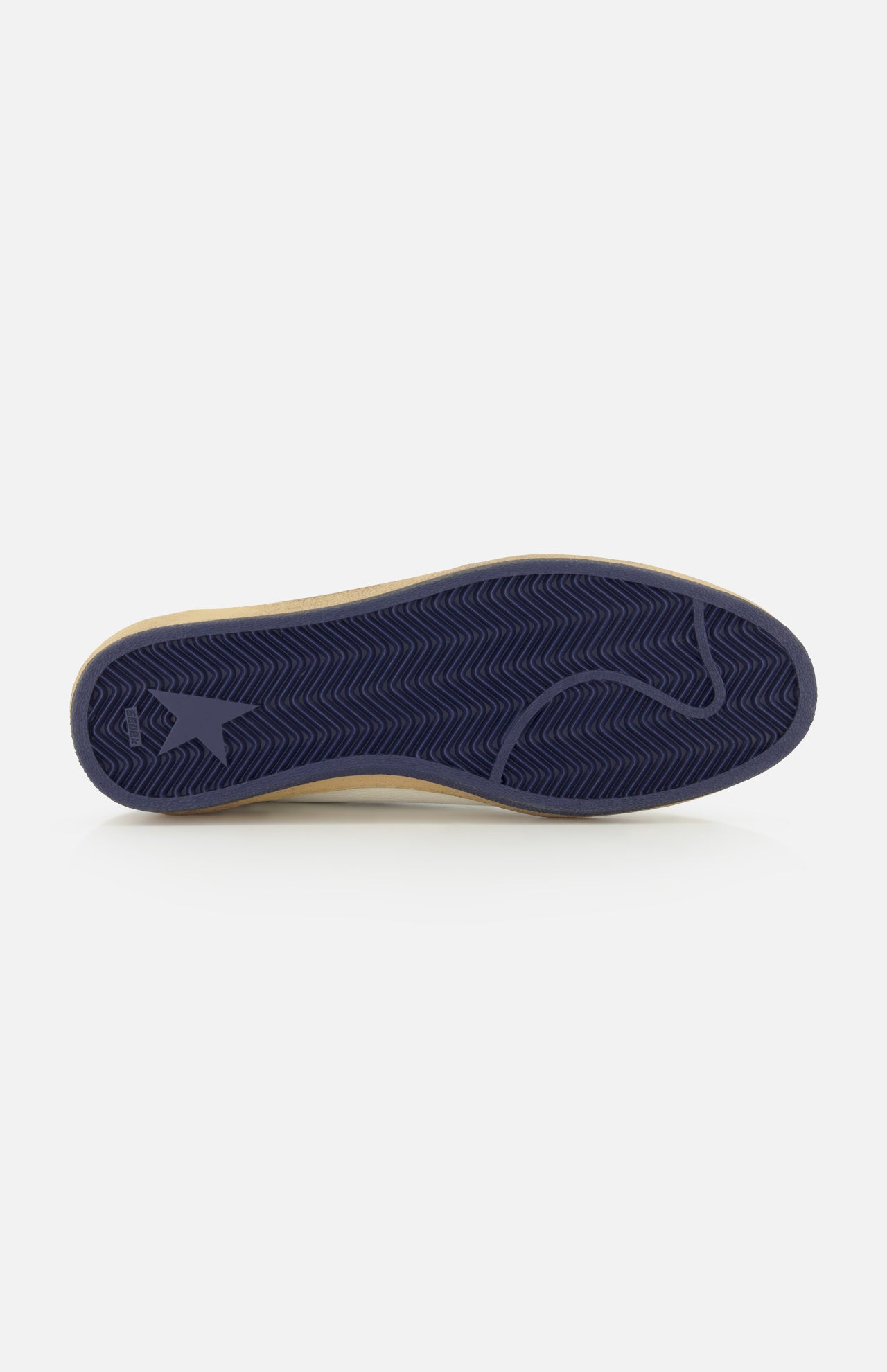 The image showcases the navy blue rubber sole of the GOLDEN GOOSE Ballstar Nappa Upper Sneaker, featuring a herringbone tread pattern and a logo detail near the heel. Reminiscent of Golden Goose’s distinctive design aesthetic, this sneaker sole stands out against the clean, white background.