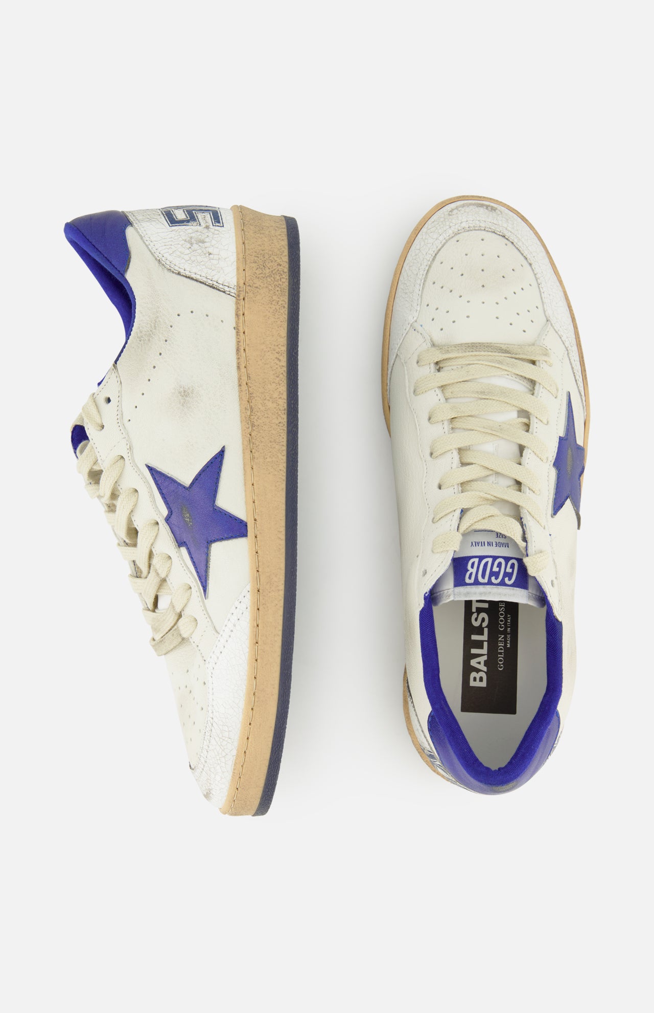 A pair of GOLDEN GOOSE Ballstar Nappa Upper Sneakers in off-white leather with blue accents, signature side star detailing, and beige soles with a deliberately distressed finish. One sneaker is displayed from the side and the other from above, both set against a plain white background.