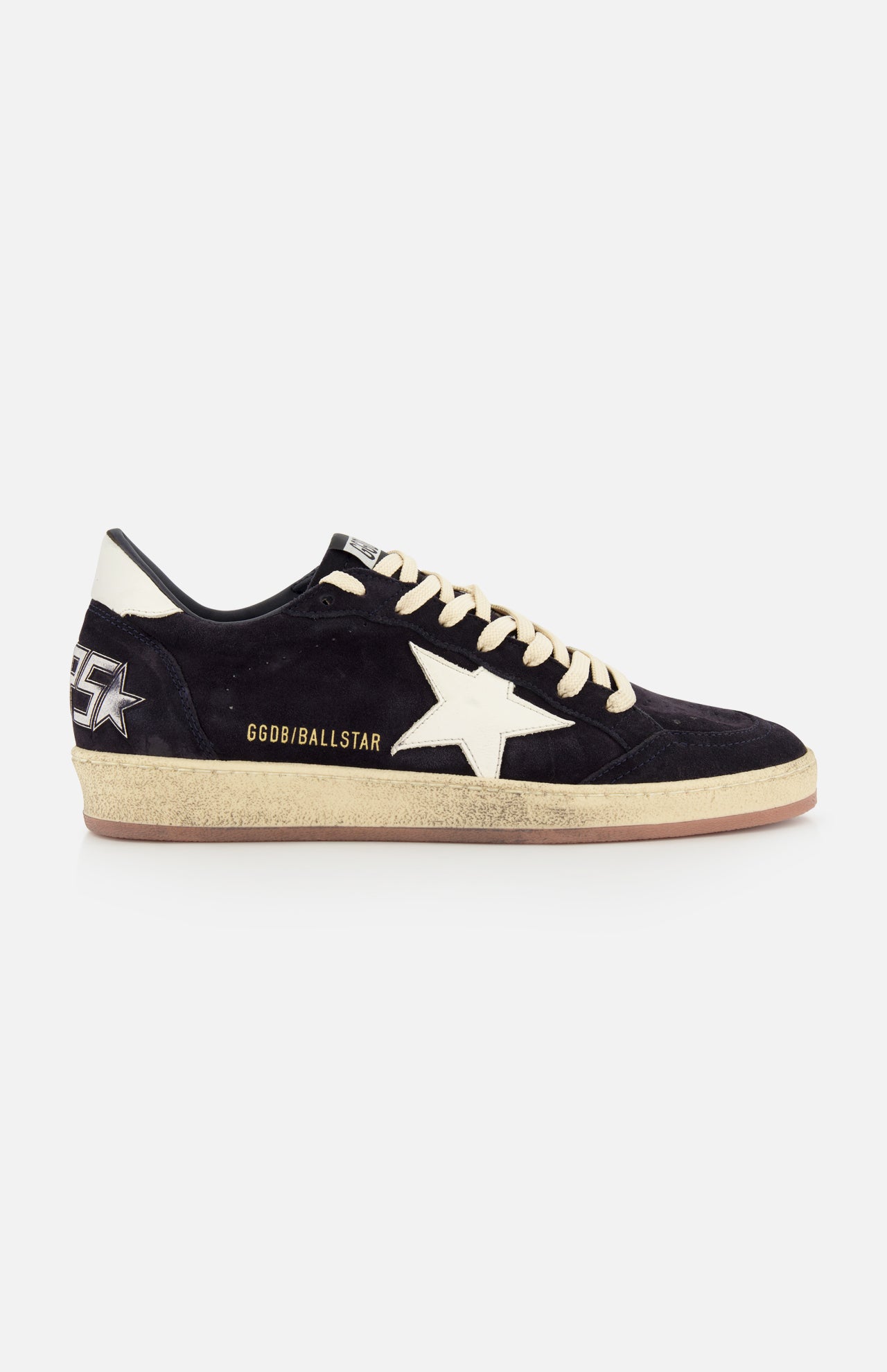 The GOLDEN GOOSE Ballstar Suede Upper Sneaker features a black low-top design, beige laces, an off-white star, gold GGDB/BALLSTAR text, a scuffed sole, and a graphic star with GGDB lettering on the heel.