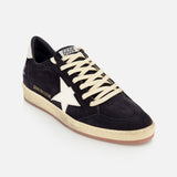 The Ballstar Suede Upper Sneaker by GOLDEN GOOSE features a black low-top suede design, cream laces, a white star logo on the side, a beige scuffed sole, and "GGBALLSTAR" branding in white on the side.
