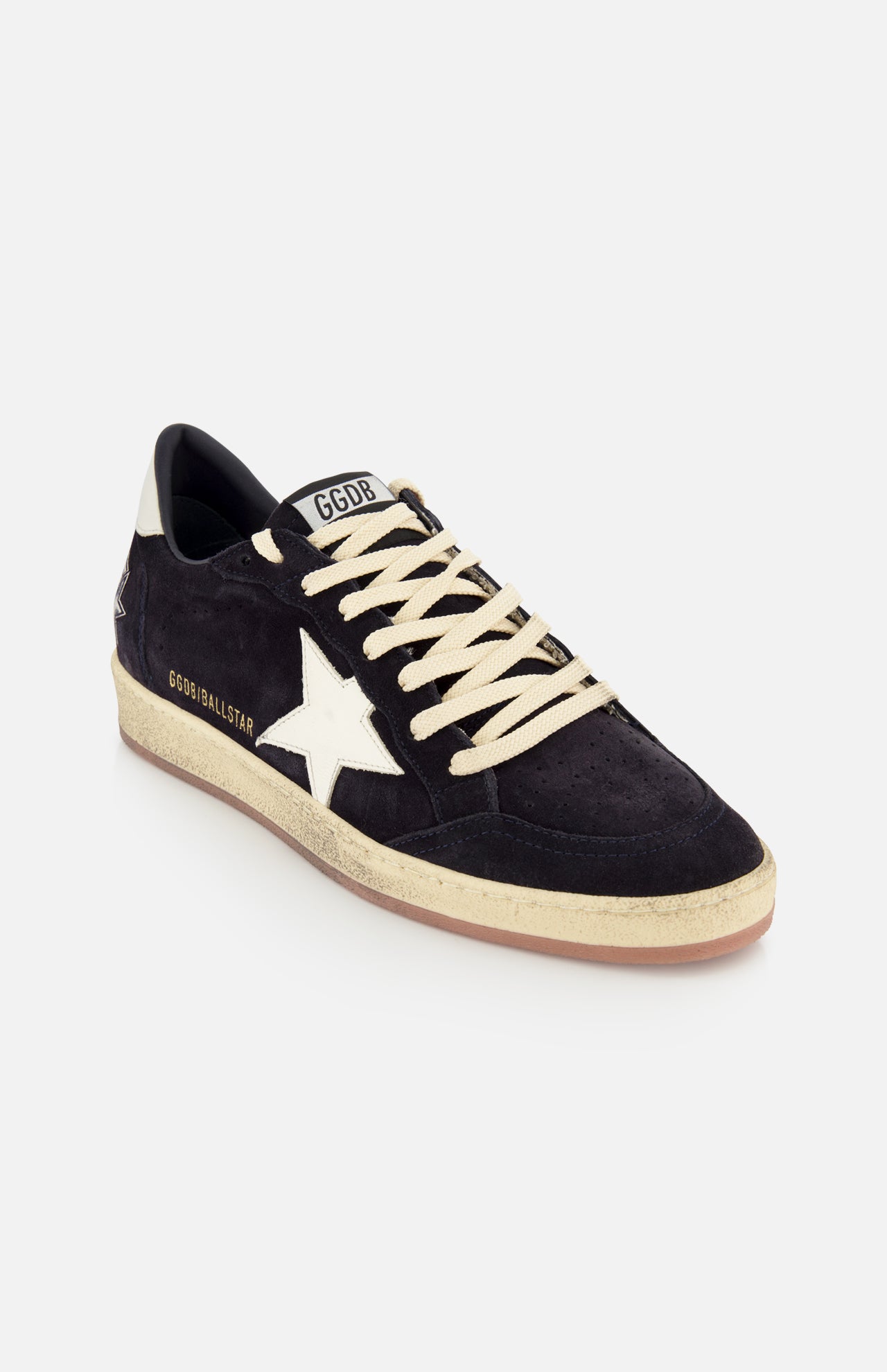 The Ballstar Suede Upper Sneaker by GOLDEN GOOSE features a black low-top suede design, cream laces, a white star logo on the side, a beige scuffed sole, and "GGBALLSTAR" branding in white on the side.