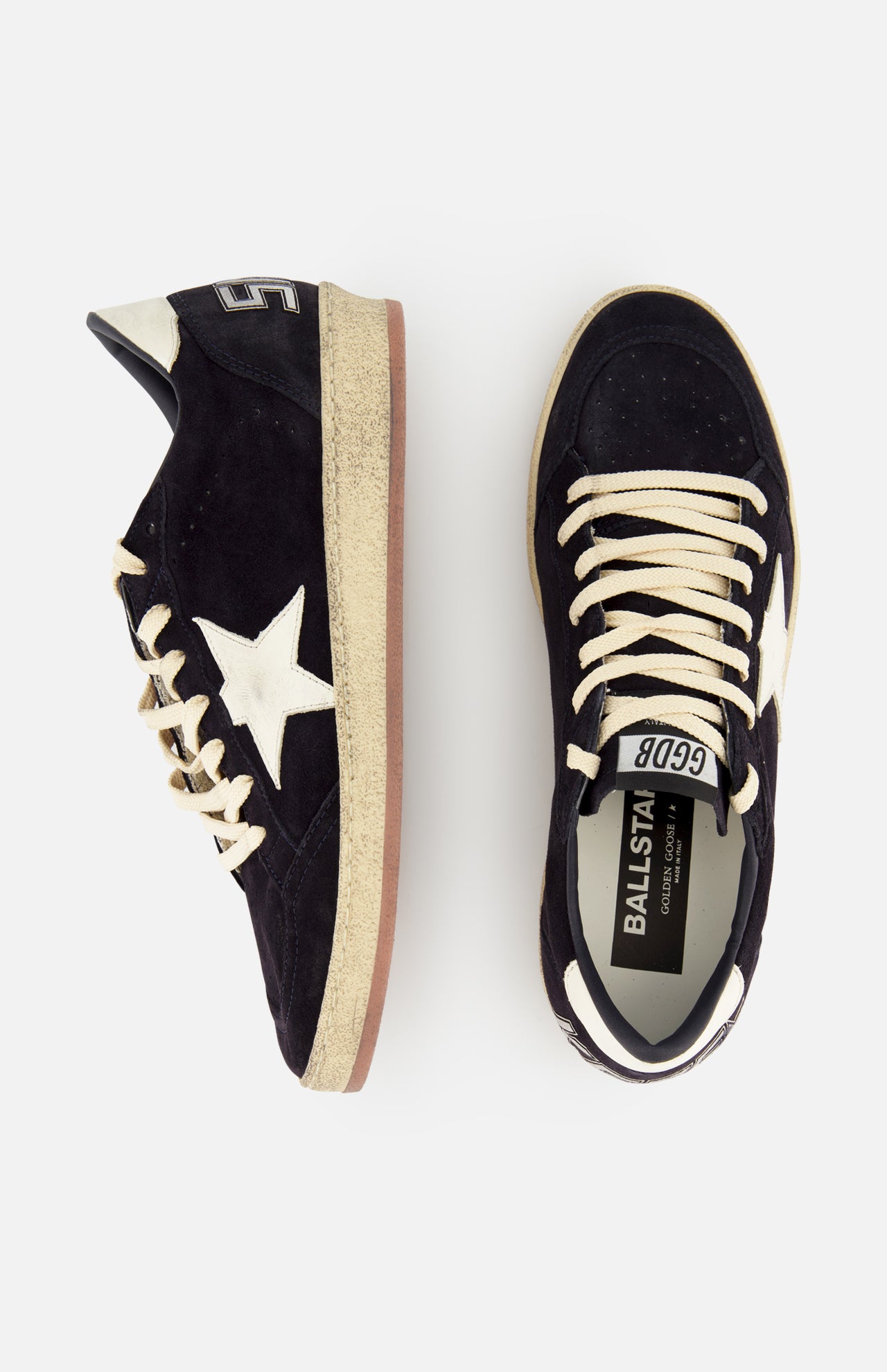 A pair of GOLDEN GOOSE Ballstar Suede Upper Sneakers featuring black suede, white laces, white star logos on the sides, and beige scuffed soles. One shoe is shown from the side, the other from above with BALLSTAR label visible on the insole.