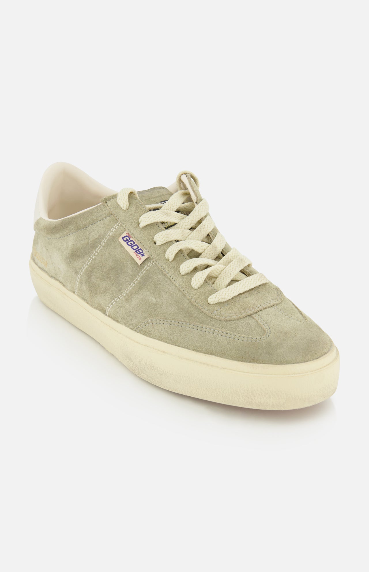 The Soul-Star Suede Sneaker by GOLDEN GOOSE is shown as a single taupe suede shoe with cream laces and a matching cream sole, accented by a subtle purple and white Gosha tag on the side, set against a plain white background.