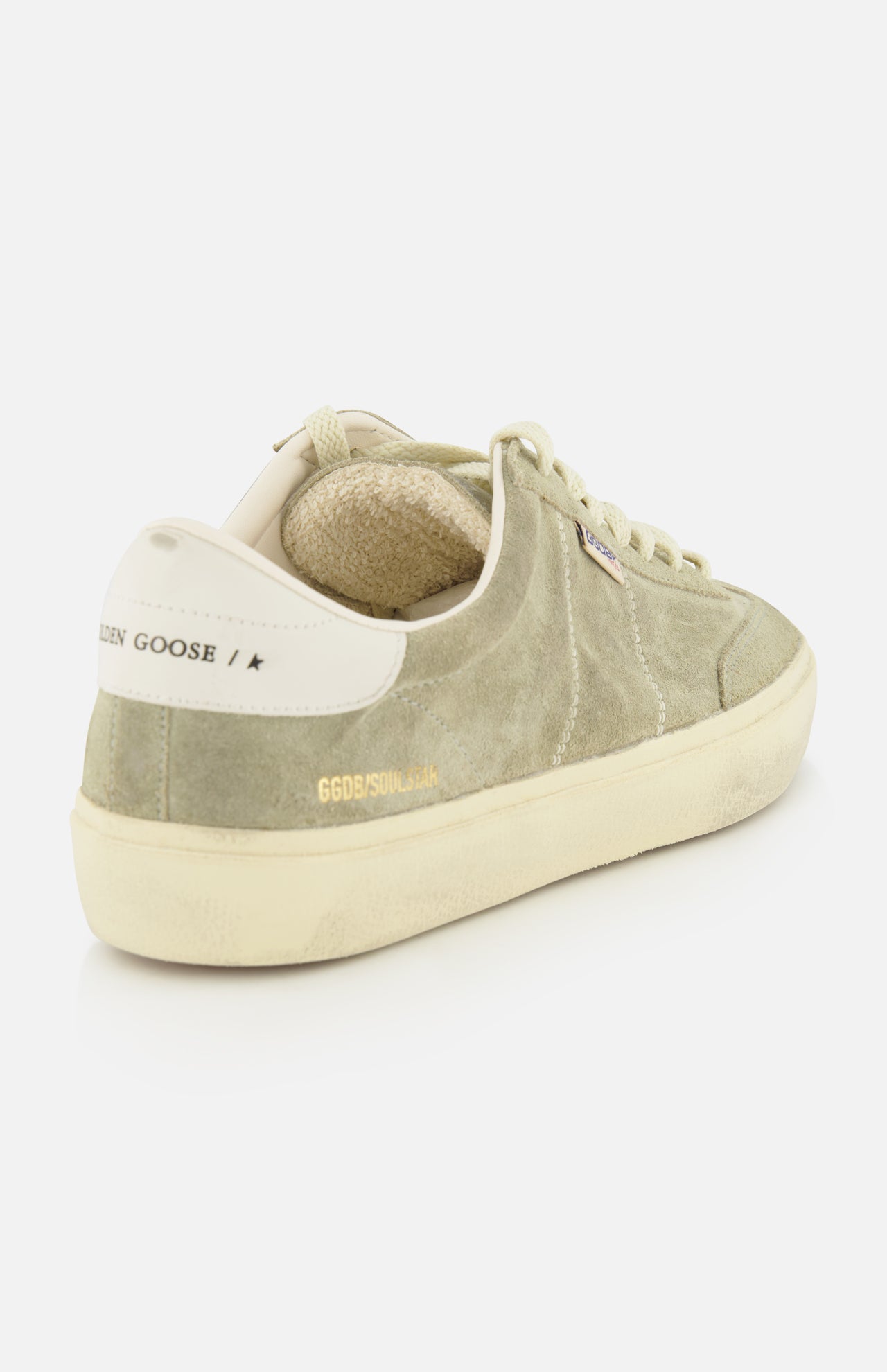 The Soul-Star Suede Sneaker by GOLDEN GOOSE features a light green premium suede upper with subtle taupe undertones, cream laces, an off-white sole, and GOLDEN GOOSE branding on the heel tab. The soft beige inner lining enhances comfort while perfectly complementing the refined color palette.