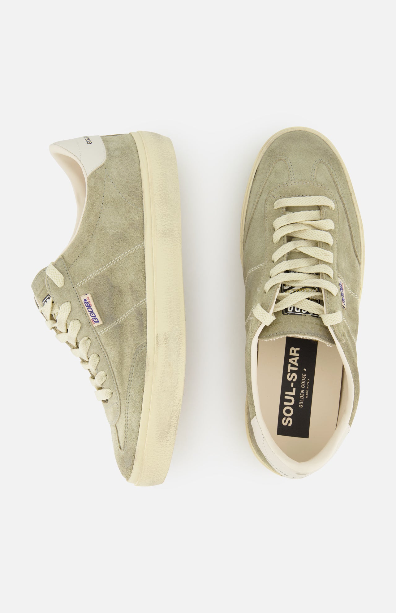 The GOLDEN GOOSE Soul-Star Suede Sneaker features a light olive green and taupe suede upper, cream laces, and matching cream soles. Displayed in side and top views against a white background, the tongue is emblazoned with “SOUL STAR,” echoing classic Golden Goose styling.
