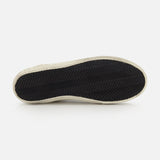 A close-up of the bottom of a GOLDEN GOOSE Super Star Nappa Upper Suede Sneaker shows its black rubber sole with herringbone tread and white outer edge, photographed against a plain white background.
