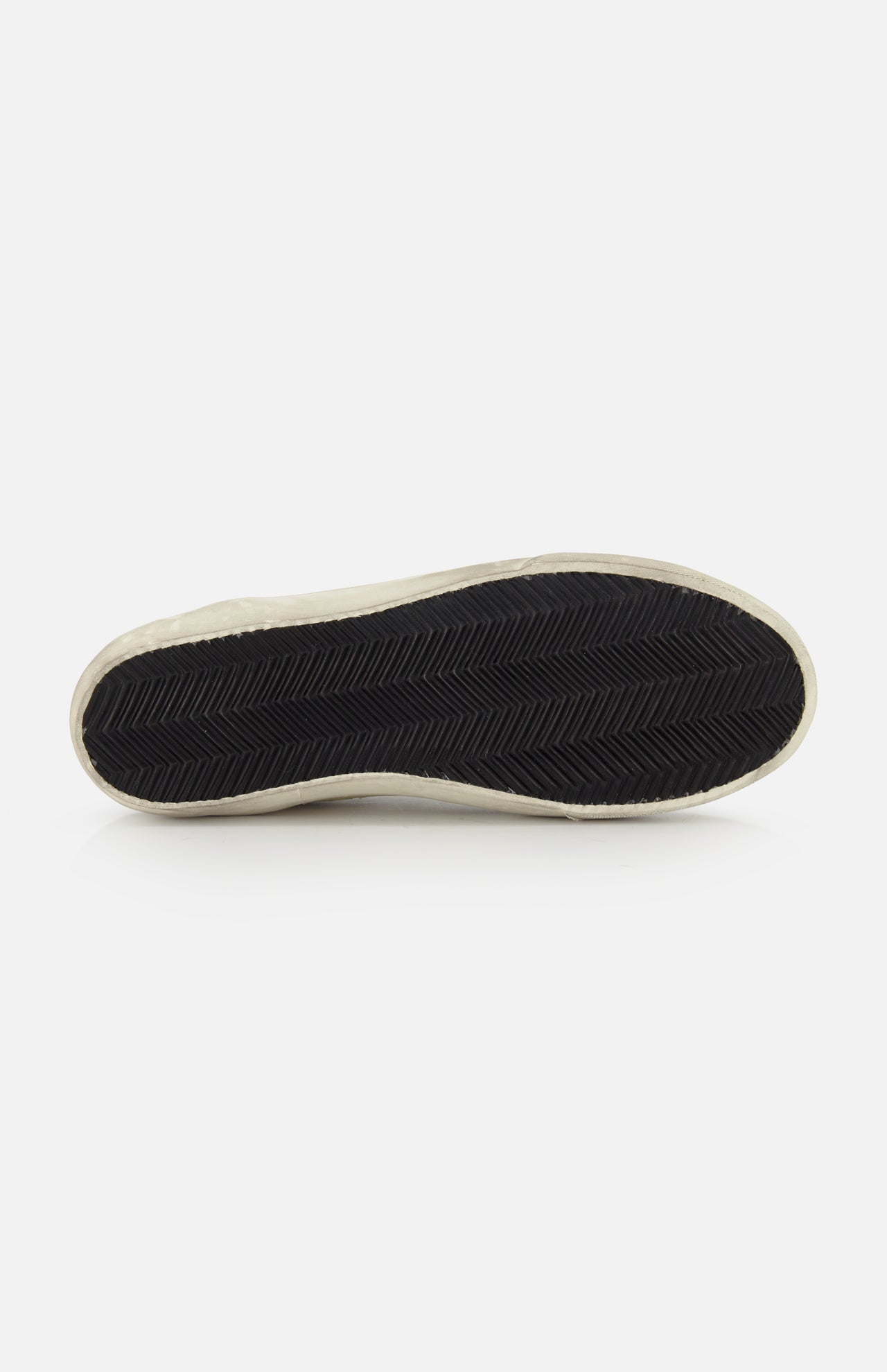 A close-up of the bottom of a GOLDEN GOOSE Super Star Nappa Upper Suede Sneaker shows its black rubber sole with herringbone tread and white outer edge, photographed against a plain white background.